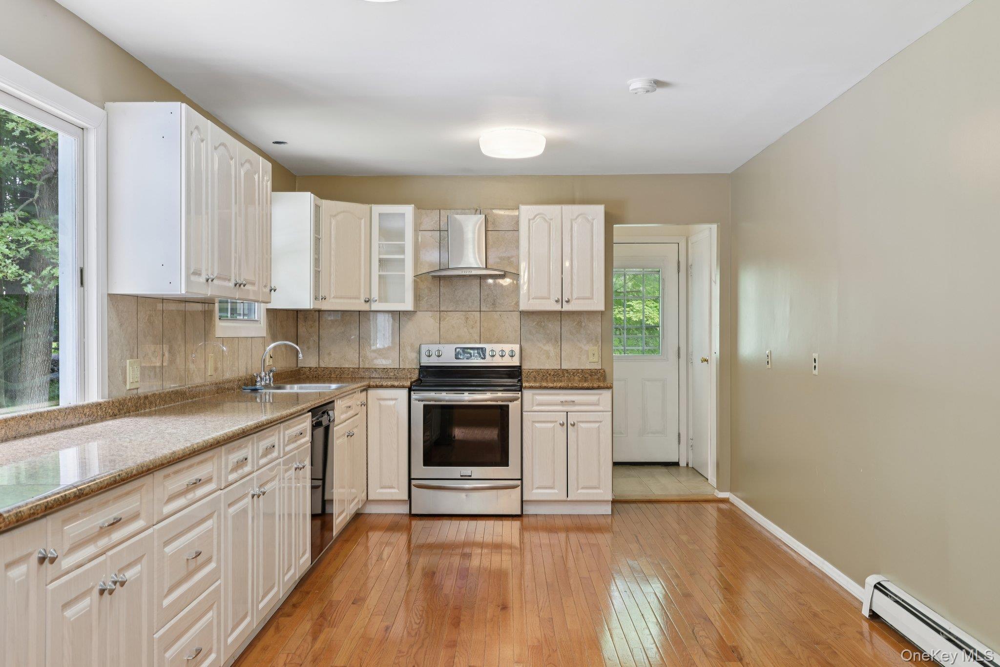 78 Pickerel Road Monroe, NY 10950 - Photo 13 of 37 a kitchen with stainless steel appliances granite countertop a stove a sink and white cabinets