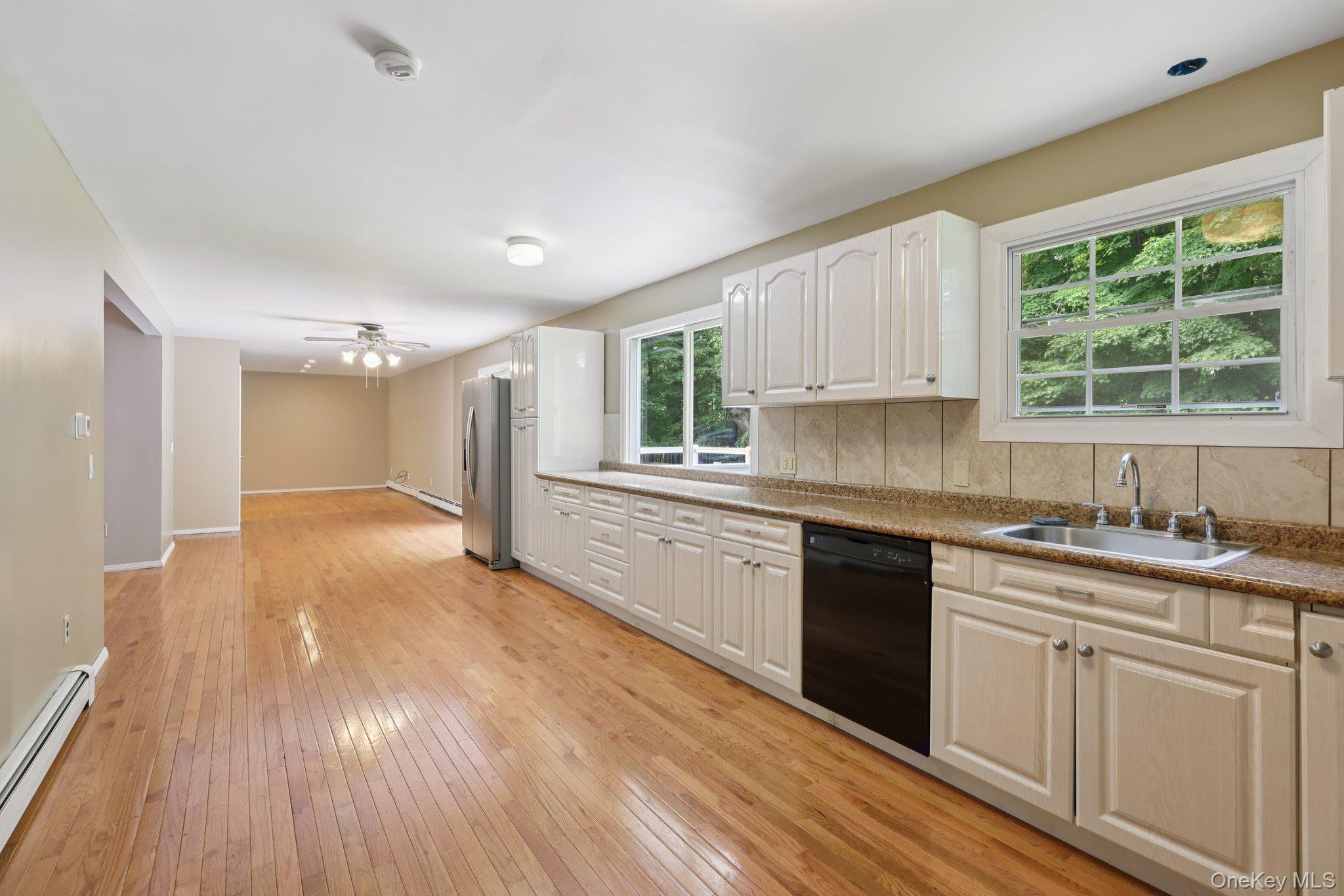 78 Pickerel Road Monroe, NY 10950 - Photo 14 of 37 a kitchen with wooden floors and white appliances