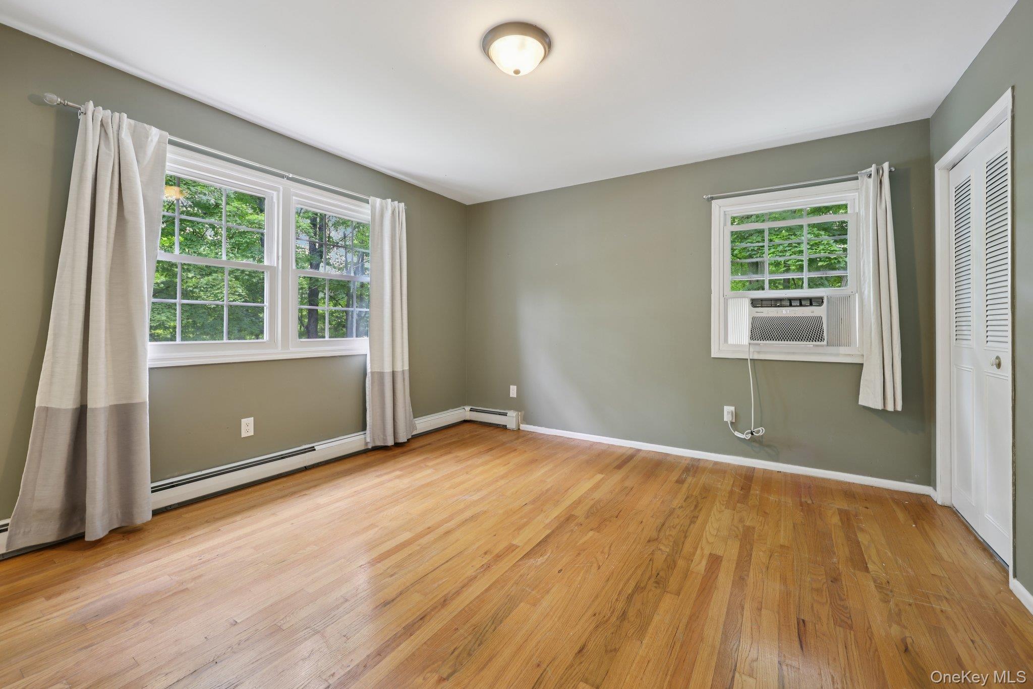 78 Pickerel Road Monroe, NY 10950 - Photo 27 of 37 an empty room with wooden floor and windows