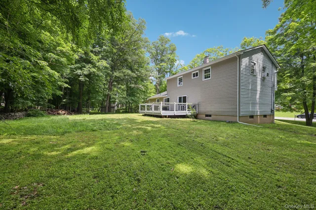 a view of a backyard with large trees