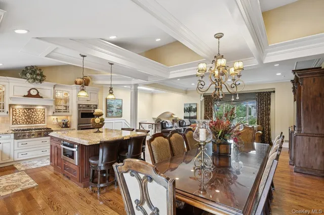 a view of a dining room with furniture a chandelier and wooden floor