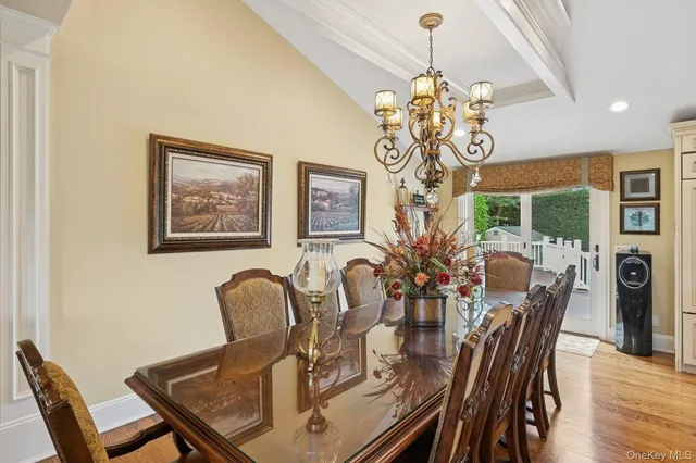 a view of a dining room with furniture chandelier and wooden floor