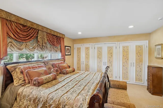 a bedroom with a bed and painting on the wall