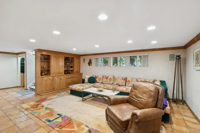 a living room with furniture and kitchen view