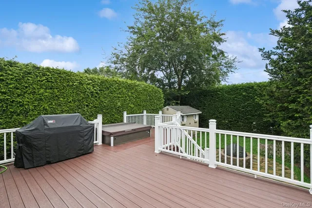 a view of a deck with couches wooden floor and fence