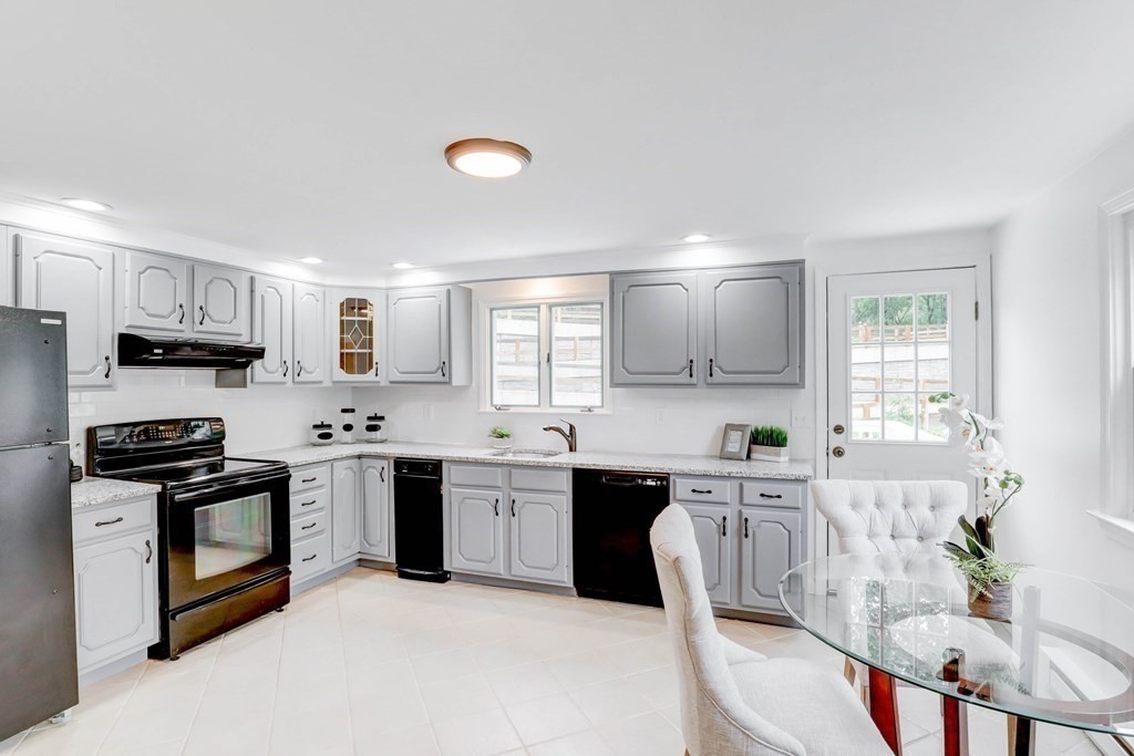 1 Gerrish Road Salisbury, MA 01952 - Photo 7 of 19 a kitchen with stainless steel appliances granite countertop a sink a stove a refrigerator cabinets and a window