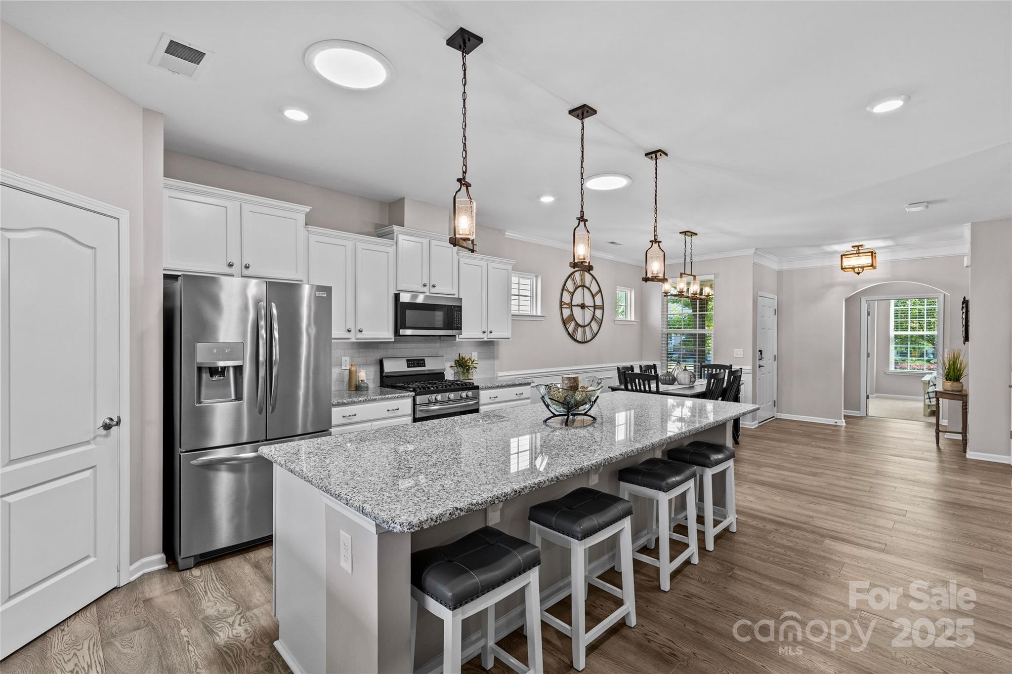 5049 Redwood Grv Trail Lancaster, SC 29720 - Photo 11 of 43 a kitchen with granite countertop a center island stainless steel appliances cabinets and wooden floor