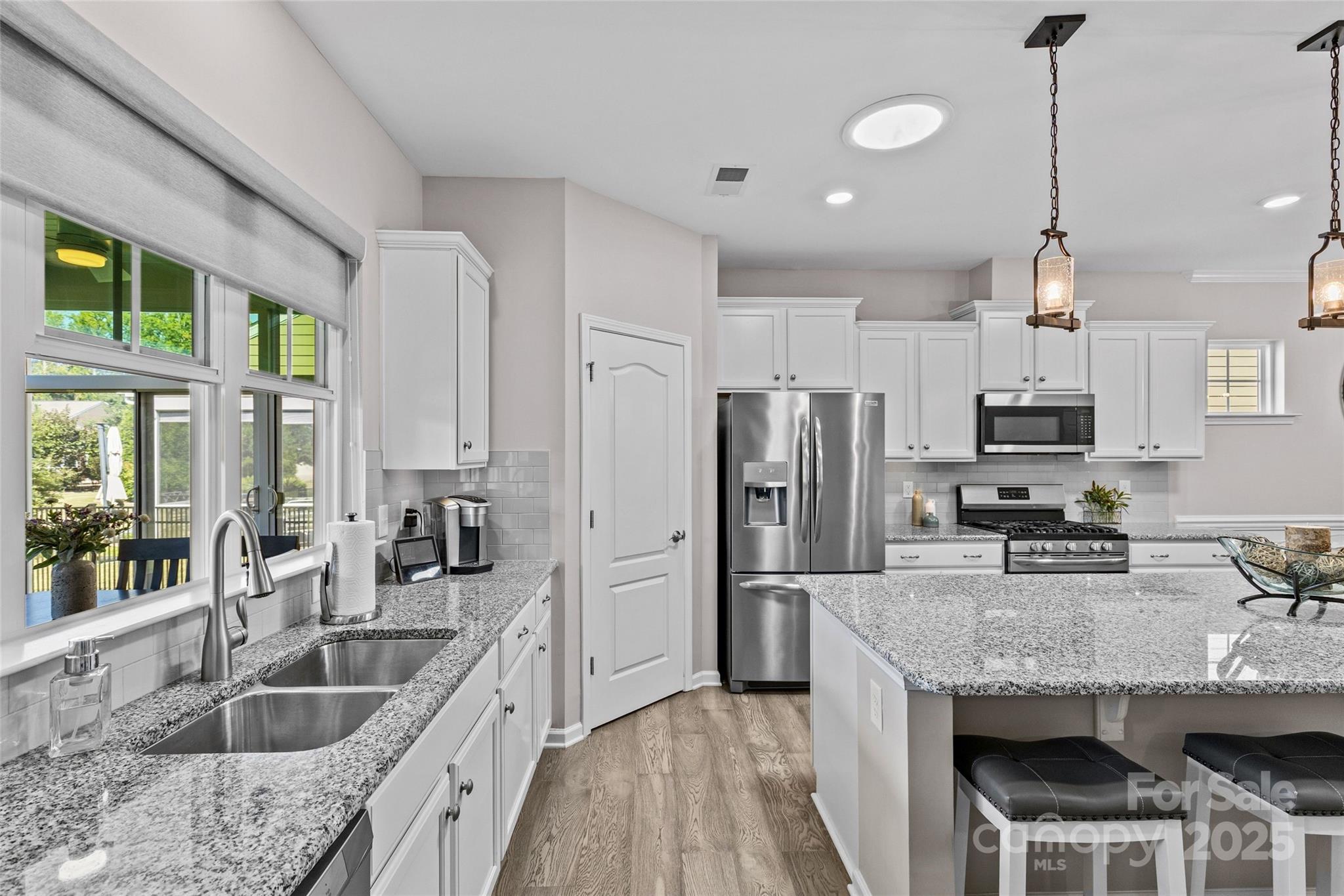 5049 Redwood Grv Trail Lancaster, SC 29720 - Photo 12 of 43 a kitchen with granite countertop kitchen island stainless steel appliances a sink and a center island