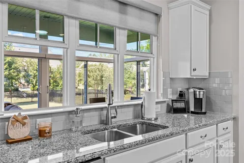 a kitchen with granite countertop a sink and a window