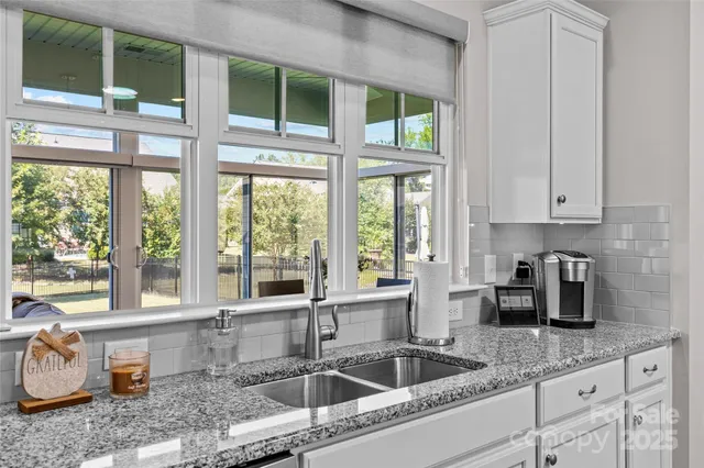 a kitchen with granite countertop a sink and a window