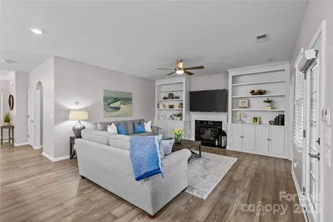 a living room with fireplace furniture and a flat screen tv