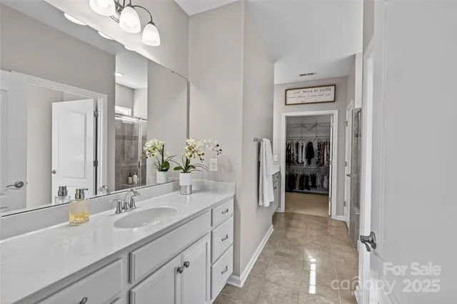 a spacious en suite bathroom with a sink and a mirror