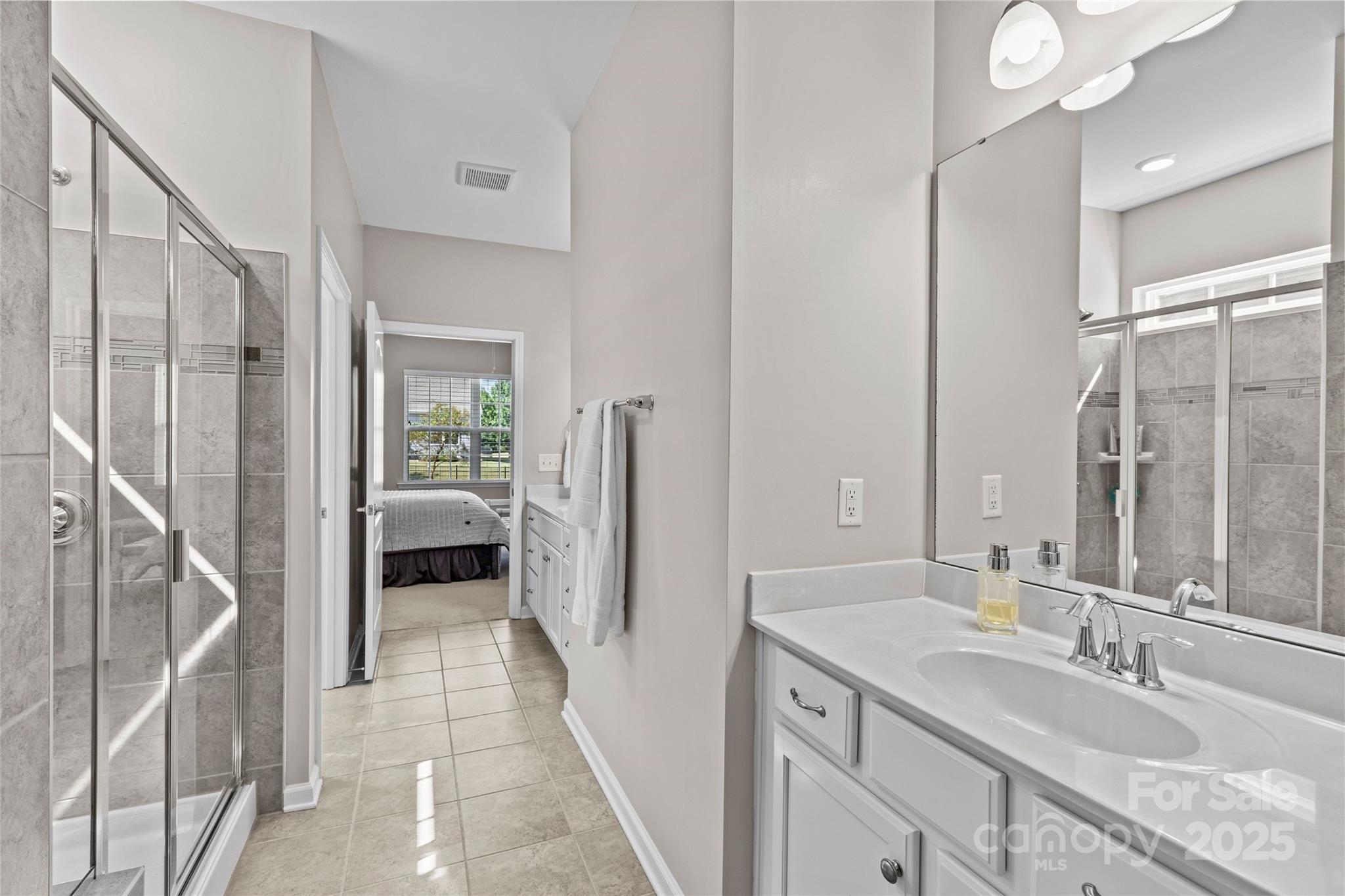 5049 Redwood Grv Trail Lancaster, SC 29720 - Photo 28 of 43 a en suite bathroom with a granite countertop sink a mirror and a shower