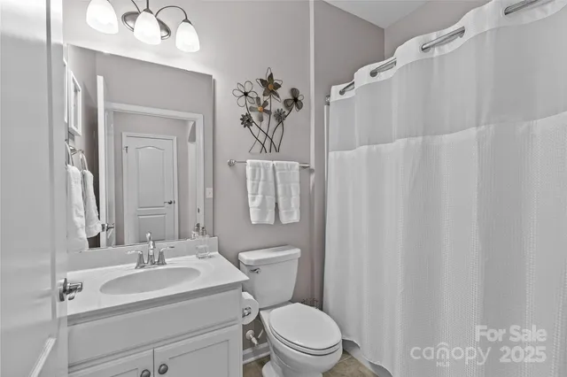 a white toilet sitting next to a bathroom sink