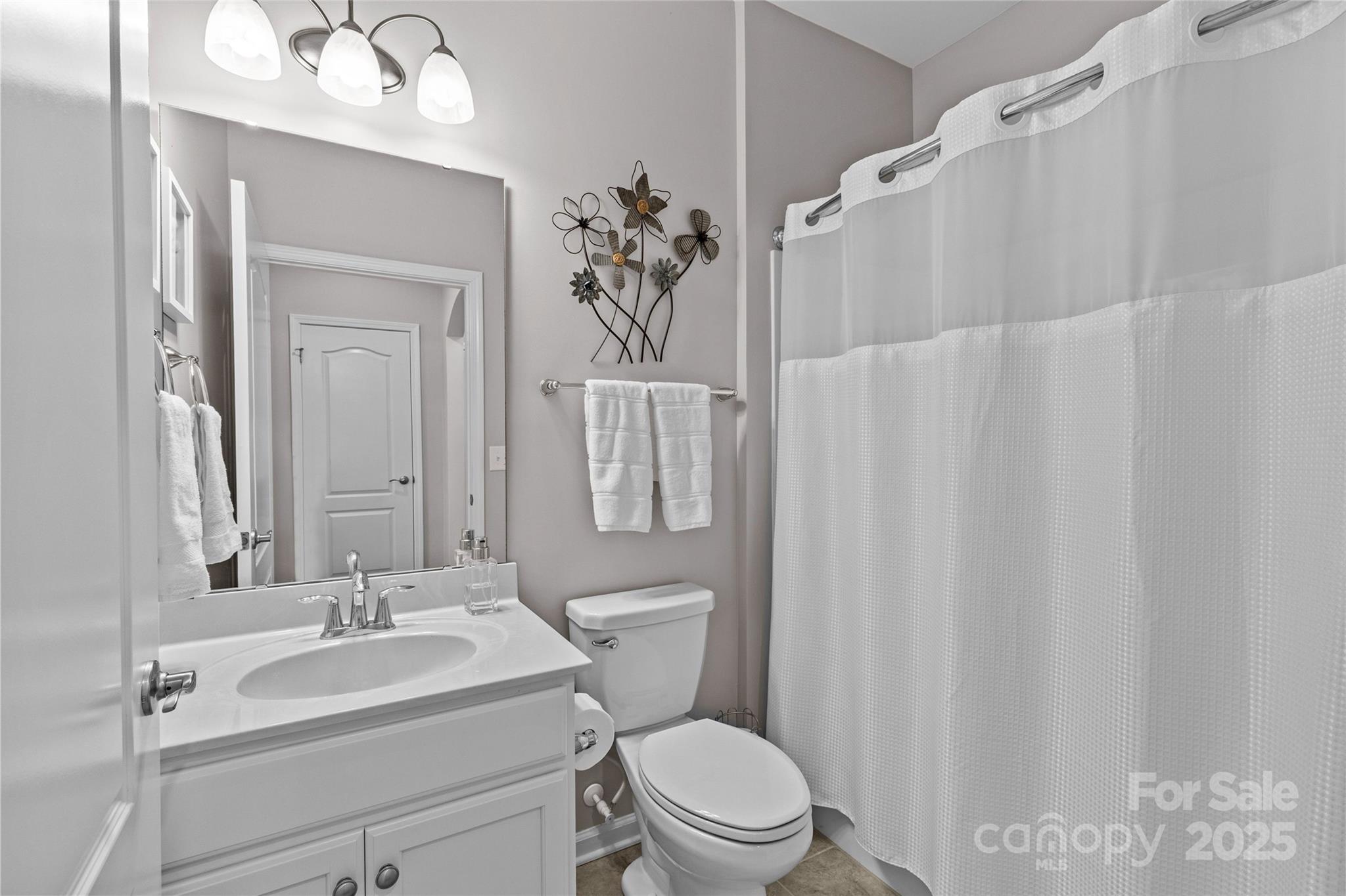 5049 Redwood Grv Trail Lancaster, SC 29720 - Photo 32 of 43 a white toilet sitting next to a bathroom sink