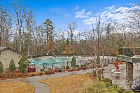 a view of a yard with cars on road