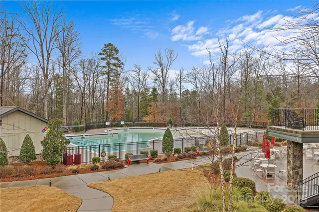 a view of a yard with cars on road