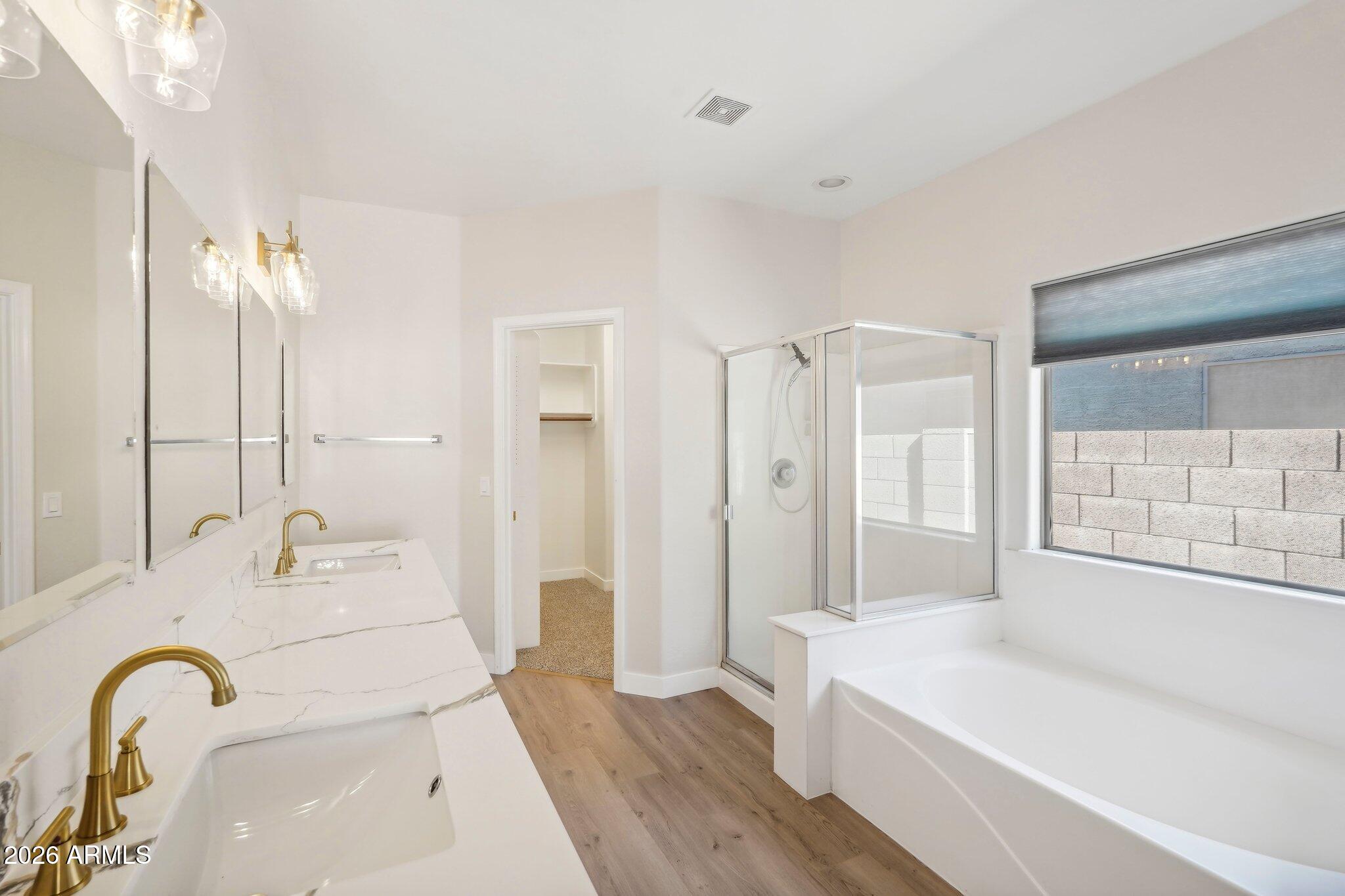 12806 West Charter Oak Road El Mirage, AZ 85335 - Photo 15 of 36 a bathroom with a tub sink and mirror