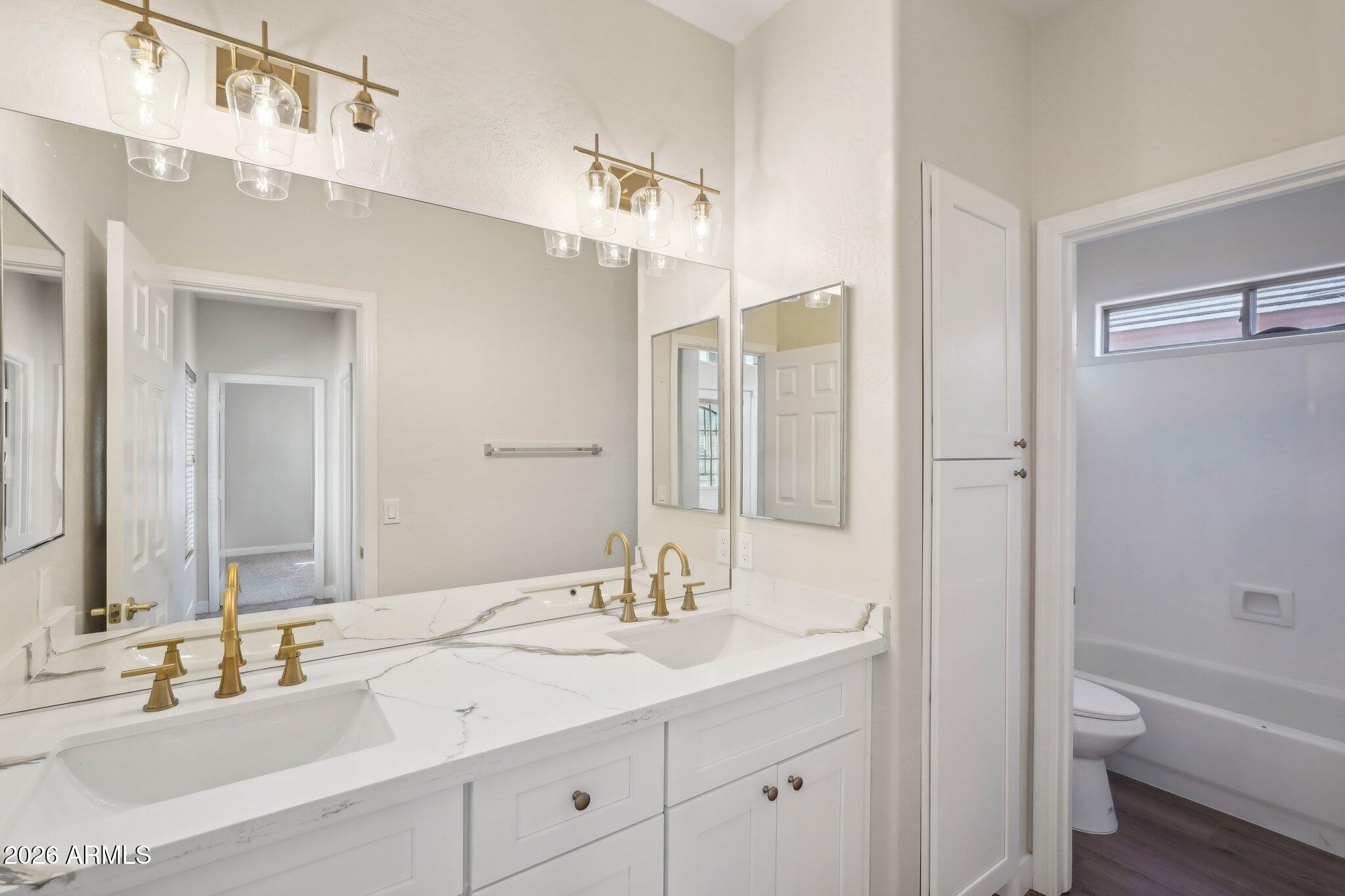 12806 West Charter Oak Road El Mirage, AZ 85335 - Photo 16 of 36 a bathroom with a granite countertop sink toilet and shower