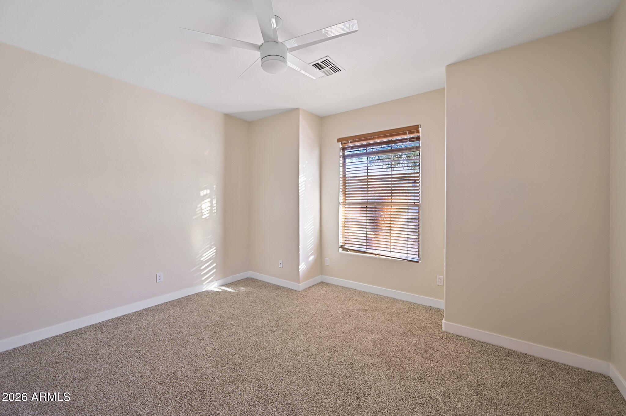 12806 West Charter Oak Road El Mirage, AZ 85335 - Photo 19 of 36 a view of an empty room with a window