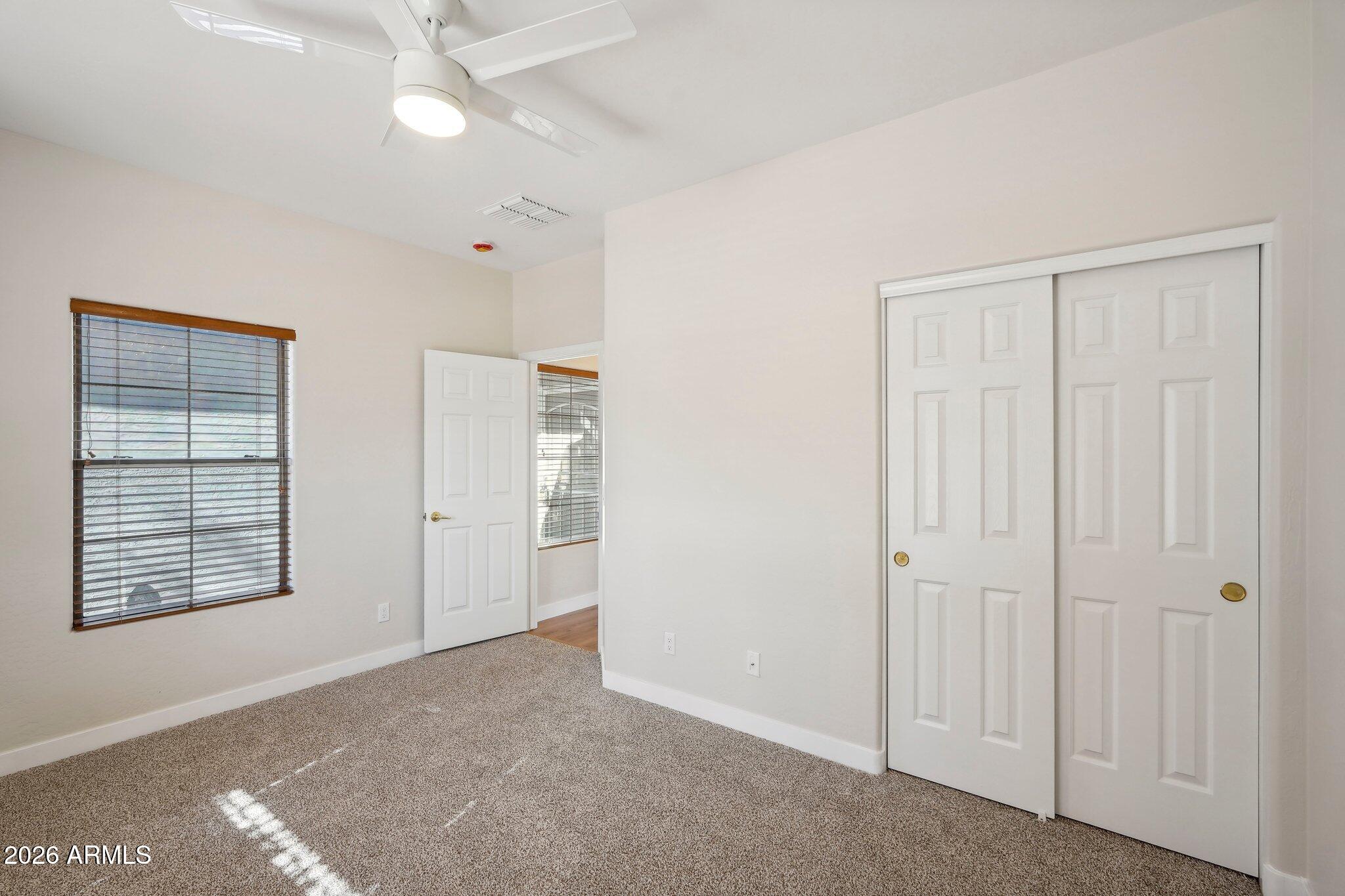 12806 West Charter Oak Road El Mirage, AZ 85335 - Photo 30 of 36 an empty room with windows and closet