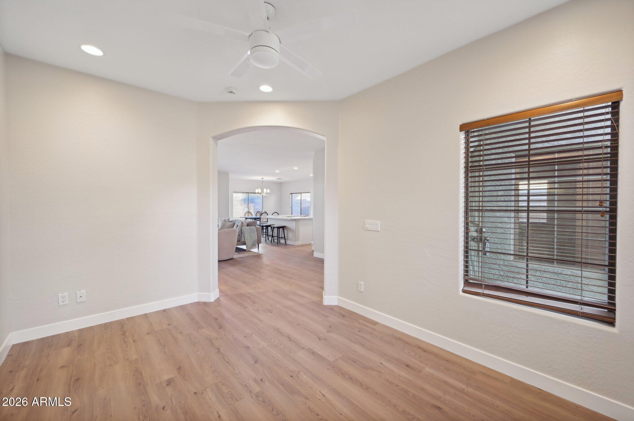 12806 West Charter Oak Road El Mirage, AZ 85335 - Photo 3 of 36 wooden floor in an empty room with a window