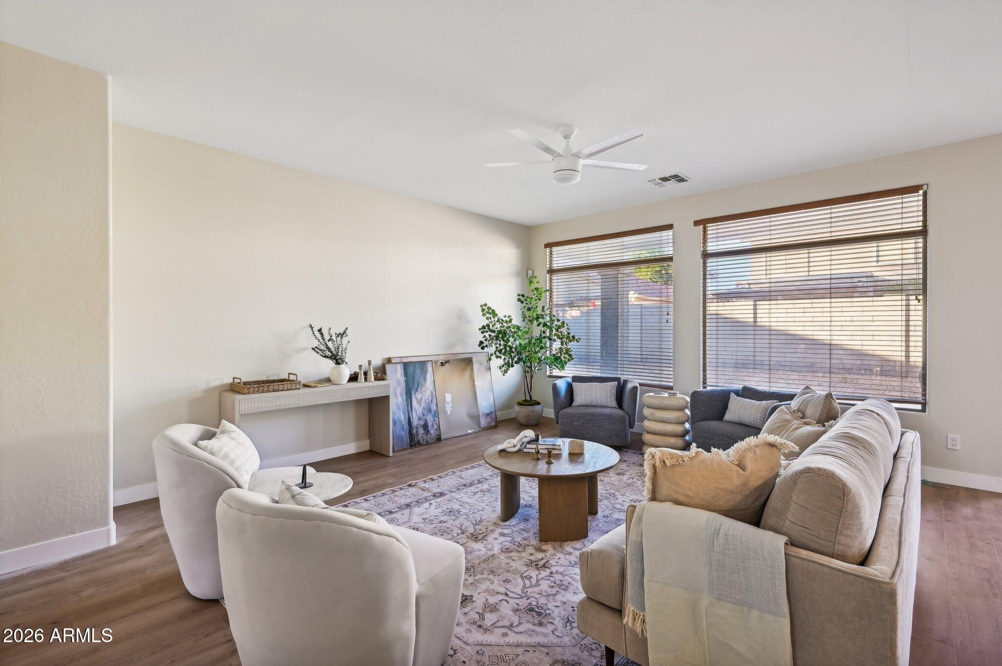 12806 West Charter Oak Road El Mirage, AZ 85335 - Photo 6 of 36 a living room with furniture and a large window