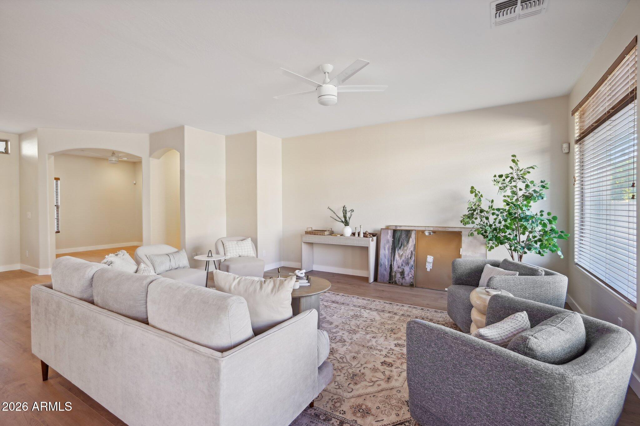 12806 West Charter Oak Road El Mirage, AZ 85335 - Photo 7 of 36 a living room with furniture and a large window