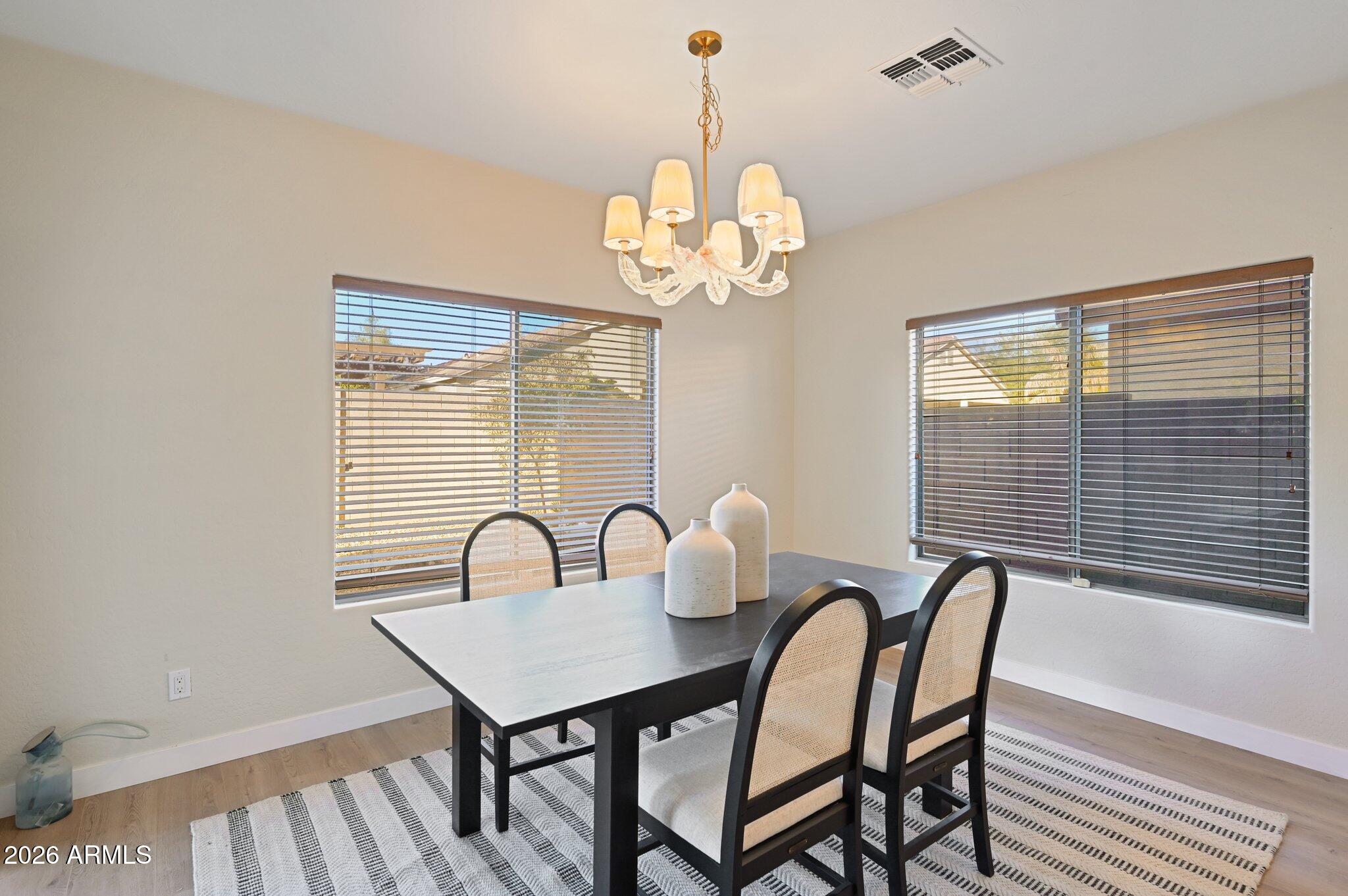 12806 West Charter Oak Road El Mirage, AZ 85335 - Photo 8 of 36 a view of a dining room with furniture and chandelier