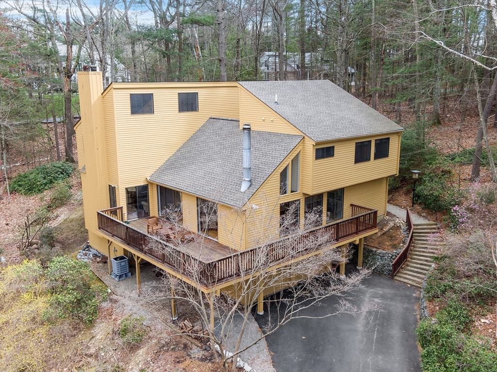 an aerial view of a house with roof deck front of house