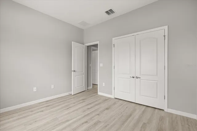 a view of an empty room and wooden floor