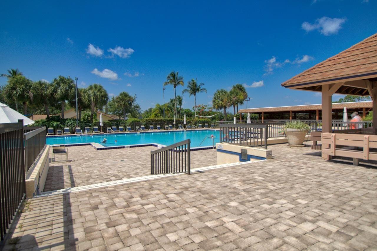 109 Harbourside Circle Jupiter, FL 33477 - Photo 3 of 4 a view of a swimming pool with sitting area