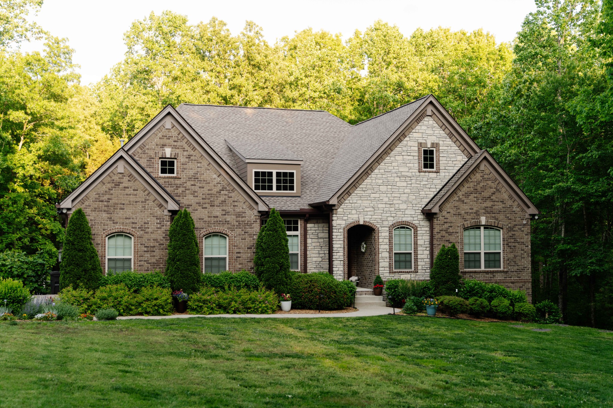 8012 Rose Rdg Lane Fairview, TN 37062 - Photo 1 of 52 a front view of a house with a yard and garage