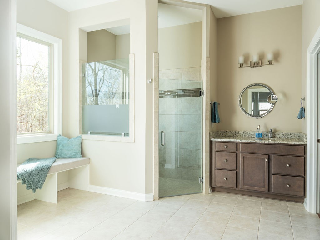 8012 Rose Rdg Lane Fairview, TN 37062 - Photo 16 of 52 a spacious bathroom with a granite countertop sink and a mirror
