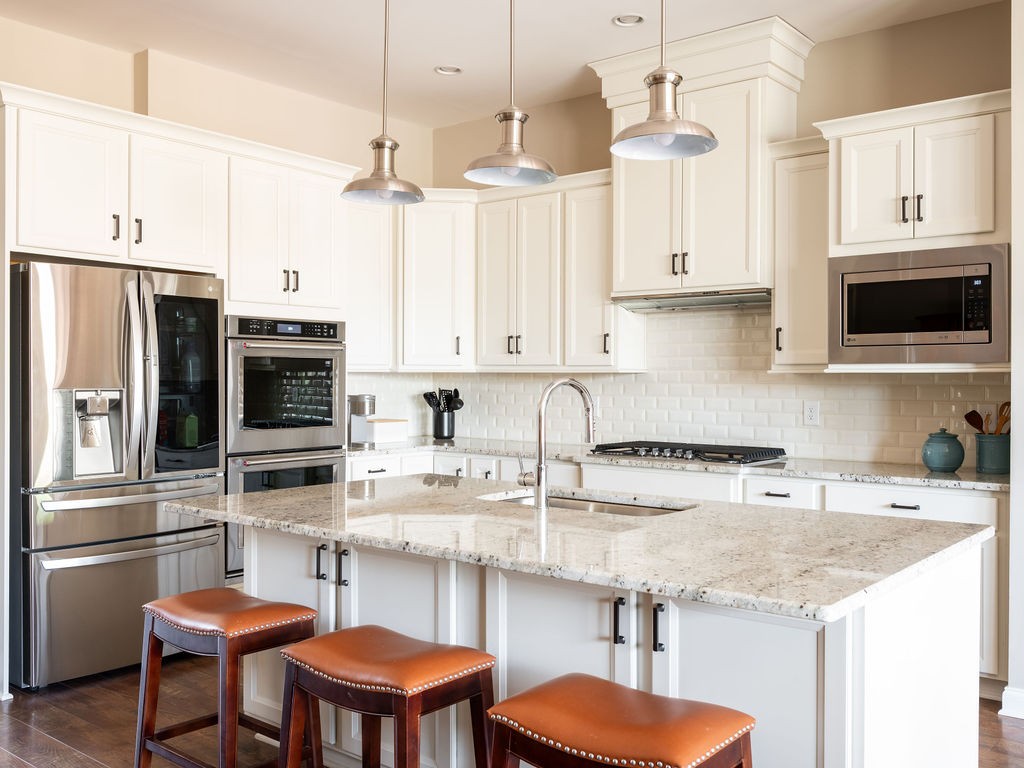8012 Rose Rdg Lane Fairview, TN 37062 - Photo 5 of 52 a kitchen with stainless steel appliances a stove center island and a refrigerator