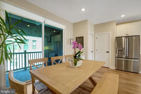 a kitchen with a table chairs and refrigerator