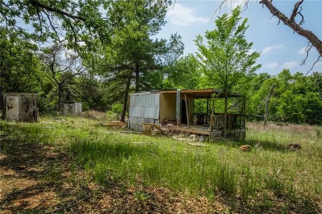 a backyard of a house with plants and outdoor seating