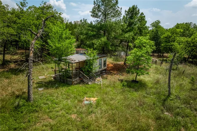 a backyard of a house with a table and chairs