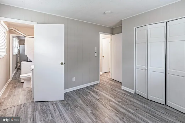 a view of hallway with wooden floor