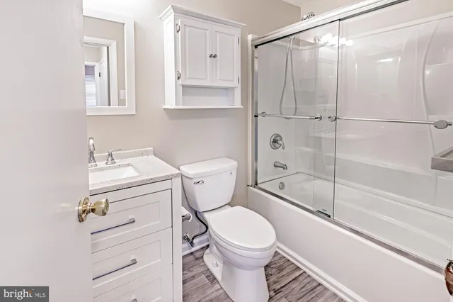 a bathroom with a toilet a sink and shower