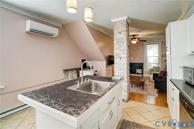 a kitchen with a sink a counter top space and stainless steel appliances