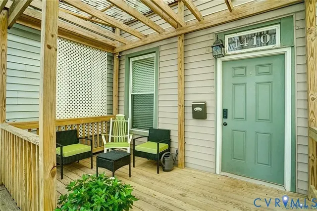 a porch with seating space and a bench