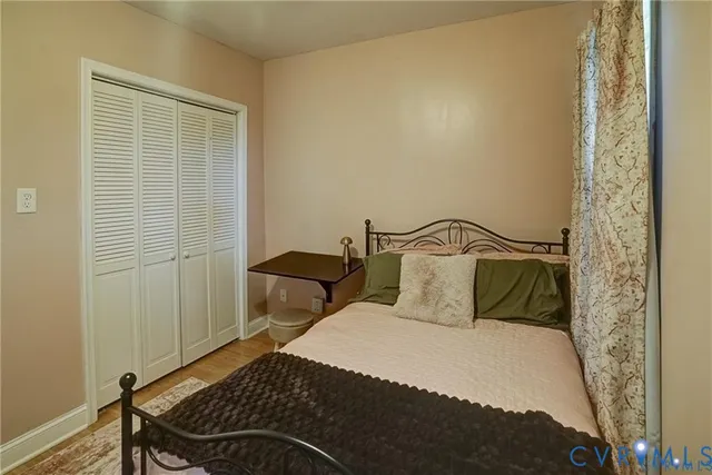 a bedroom with a bed and a mirror