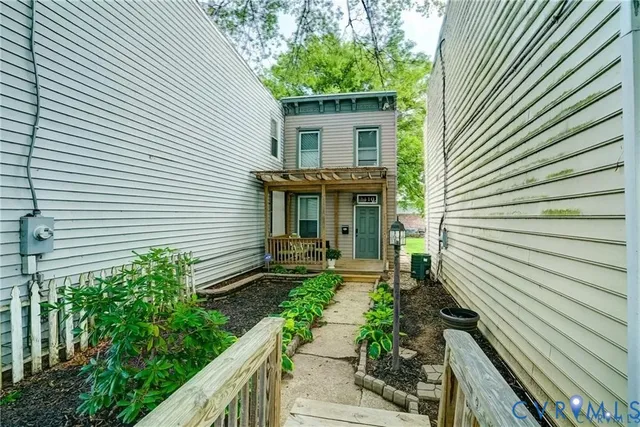a view of a house with a small yard and a potted plant