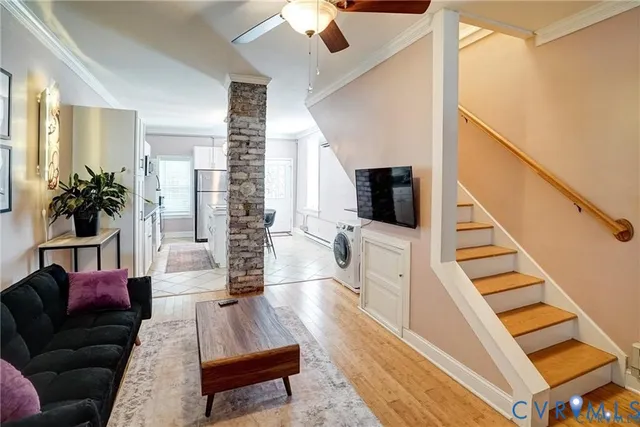 a living room with furniture and wooden floor