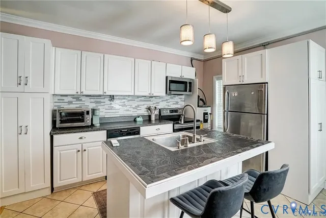 a kitchen with stainless steel appliances granite countertop a sink refrigerator stove and microwave