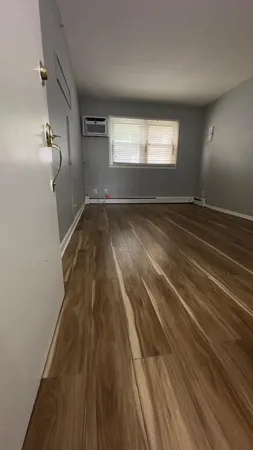 a view of an empty room and wooden floor