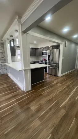 a kitchen with granite countertop a stove and cabinets