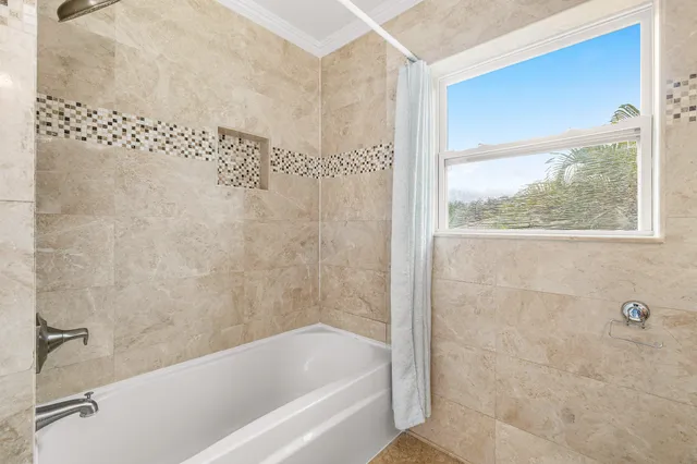 a bathroom with a bathtub and shower