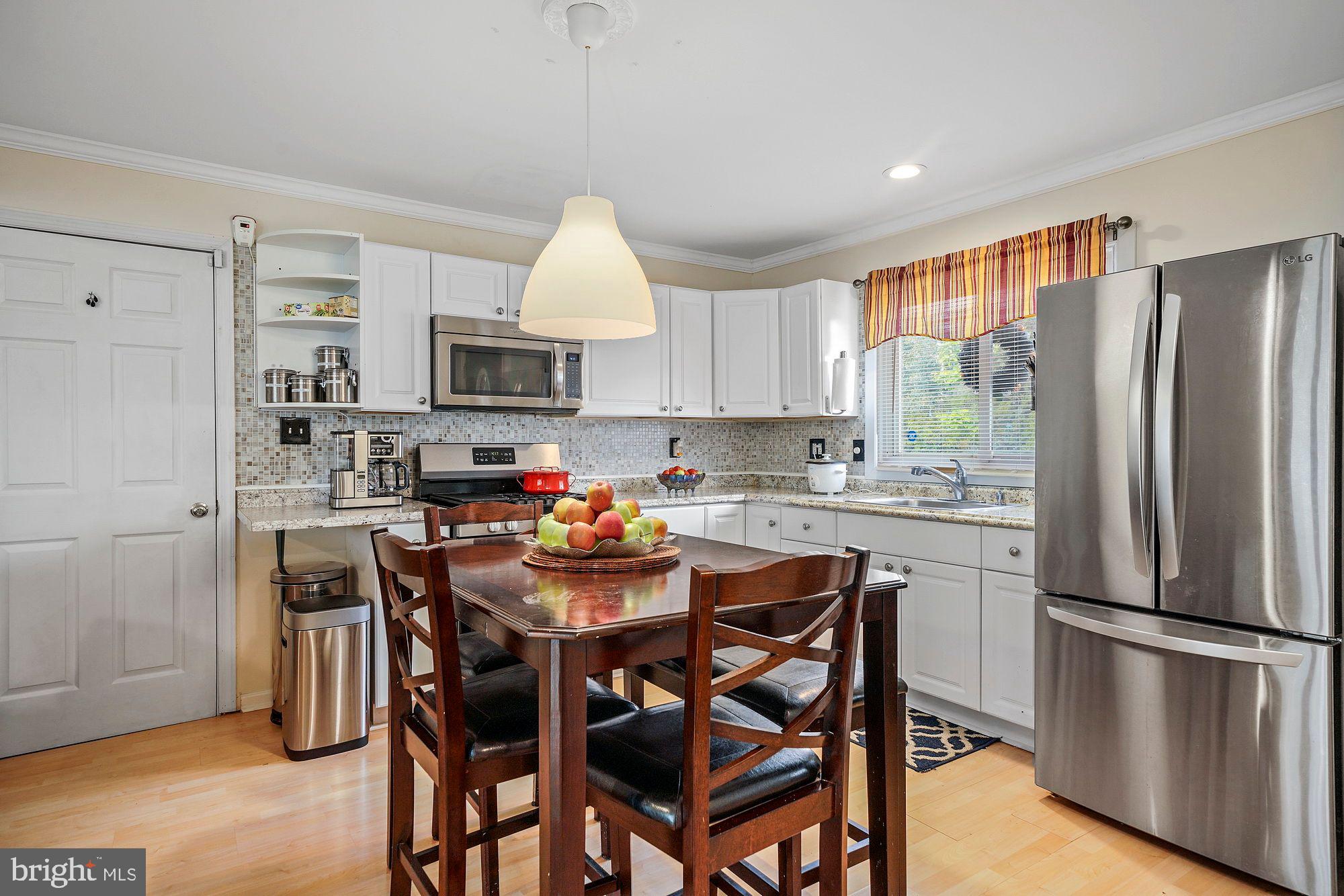 3 Albemarle Road Hamilton, NJ 08690 - Photo 3 of 27 a kitchen with stainless steel appliances a dining table chairs refrigerator and cabinets